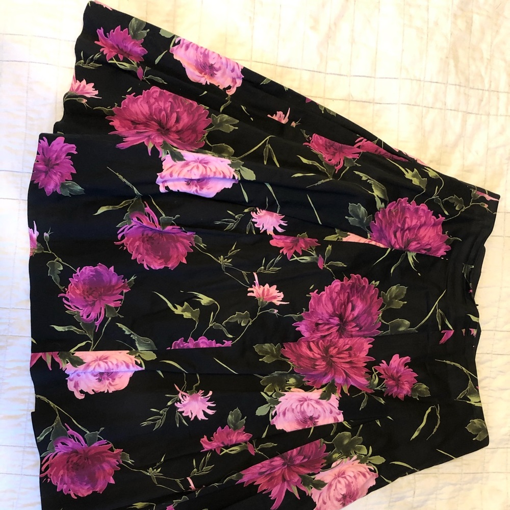 Pink flowers, green leaves on a black skirt